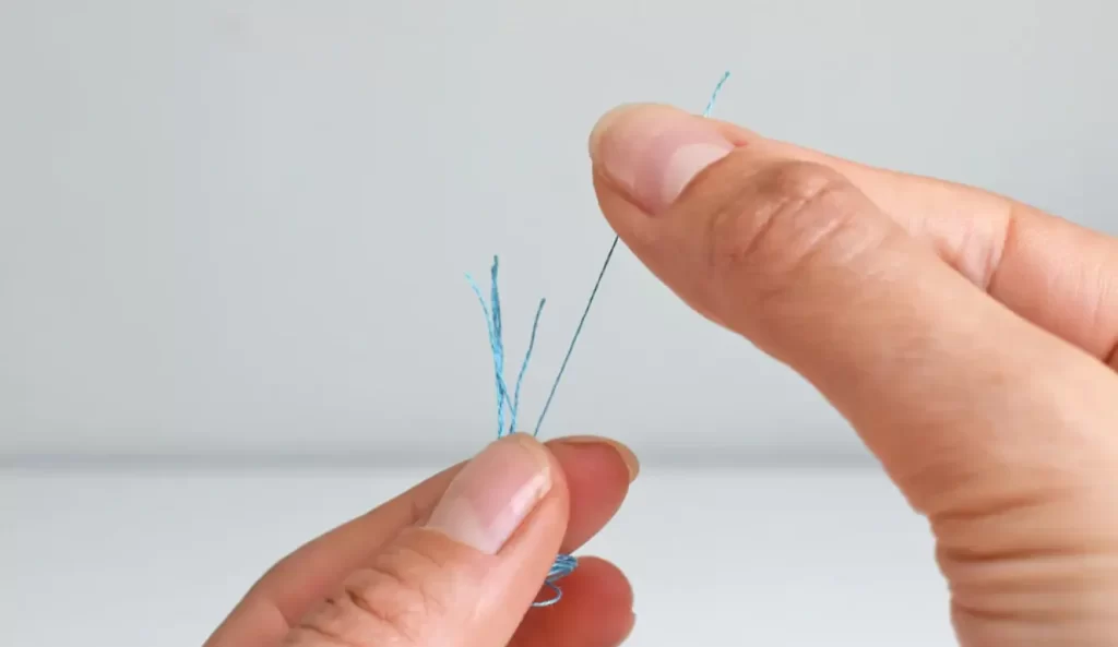 Separate strands of embroidery floss, gently pulling them apart for stitching.